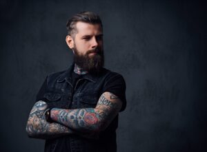 tattooed man with arms crossed