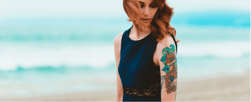 tattooed woman on the beach