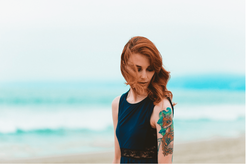 tattooed woman on the beach