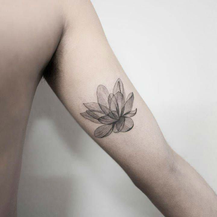 Minimalist lotus flower tattoo on the inner arm